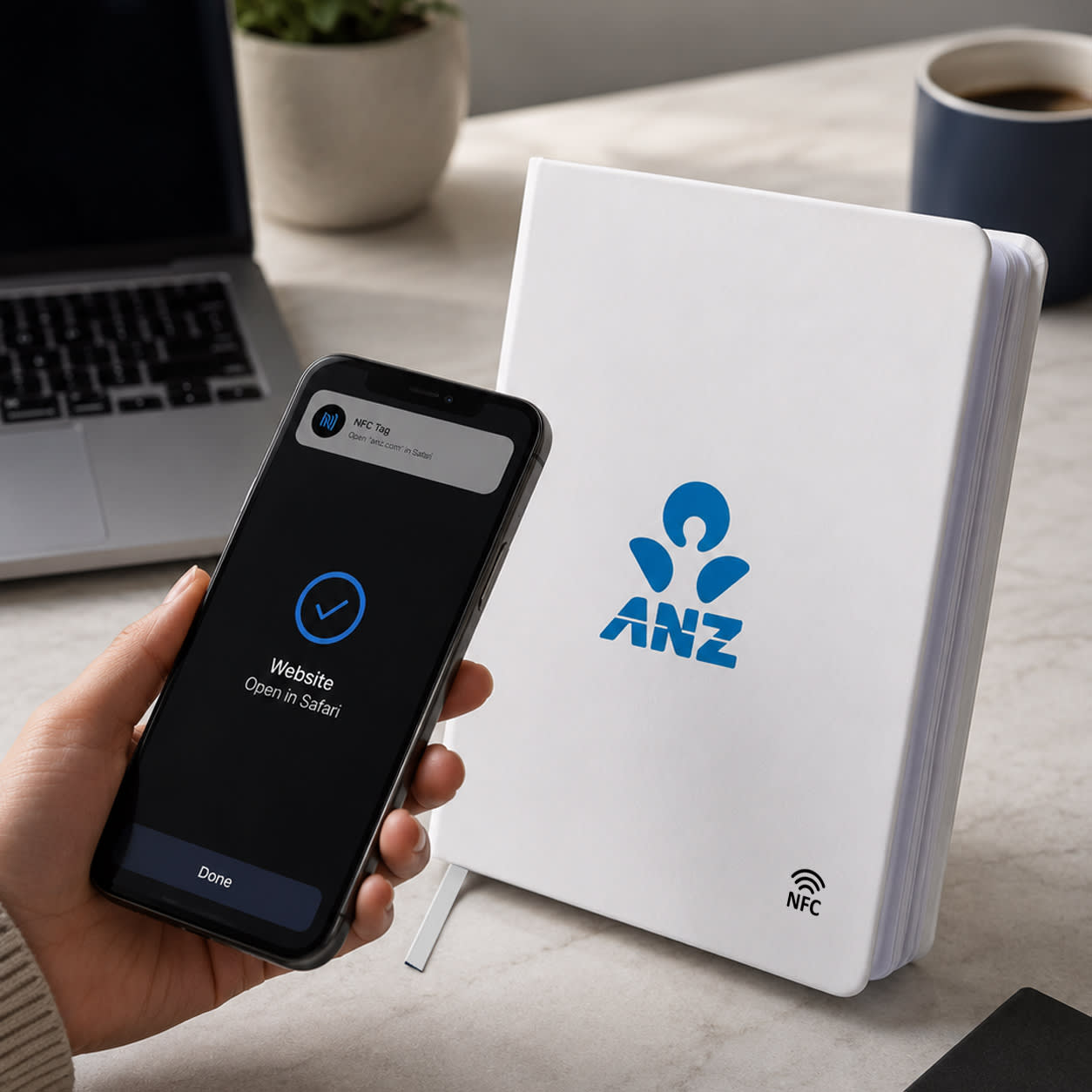 A white NFC A5 Smart Notebook features a logo, placed next to a smartphone and a laptop on a desk.