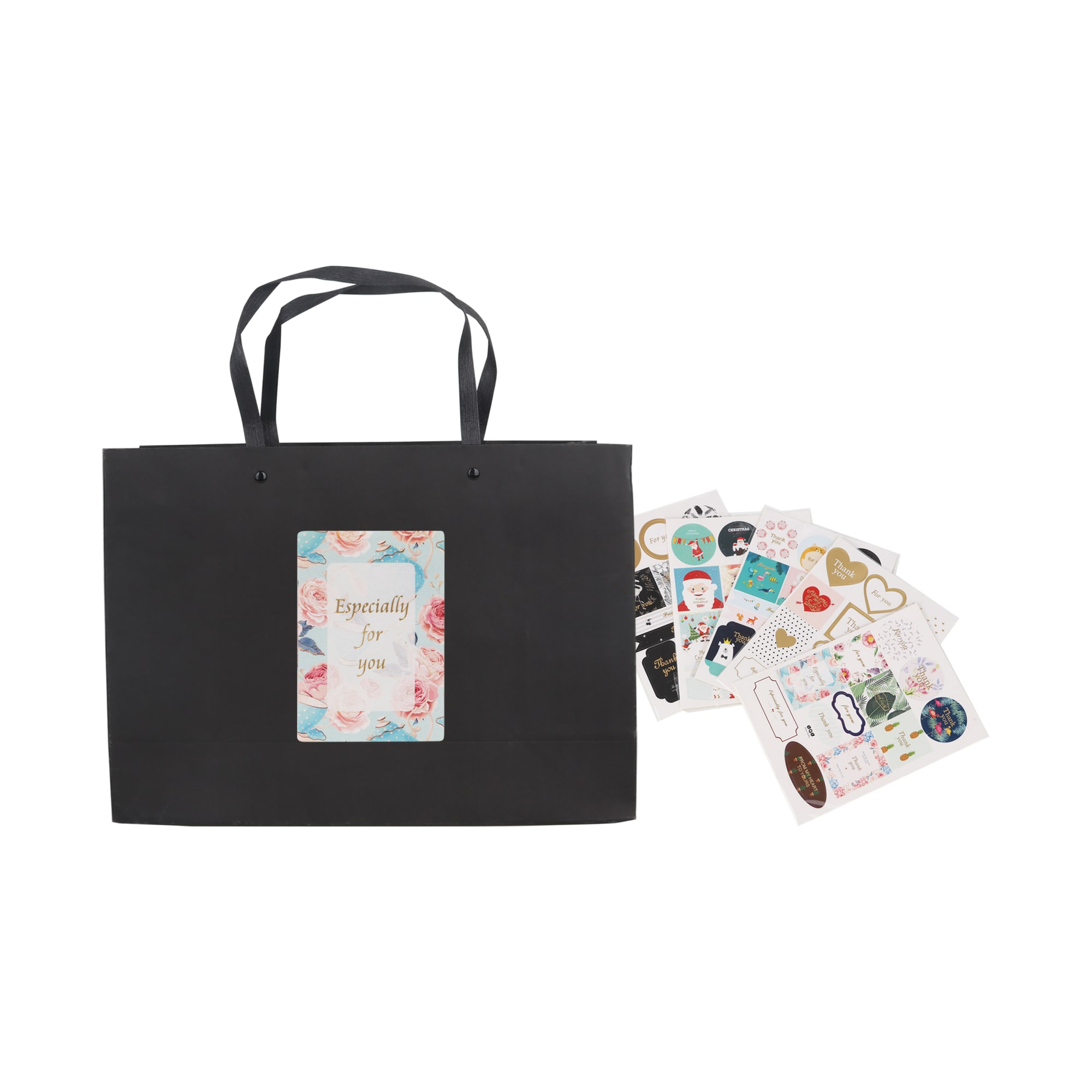 A black large crosswise paper bag with knitted handles, accompanied by various decorative stickers.