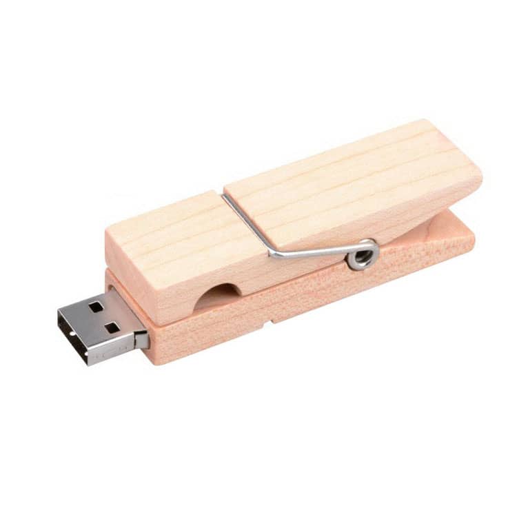A wooden clip flash drive in a natural light wood finish with a metal spring attachment.