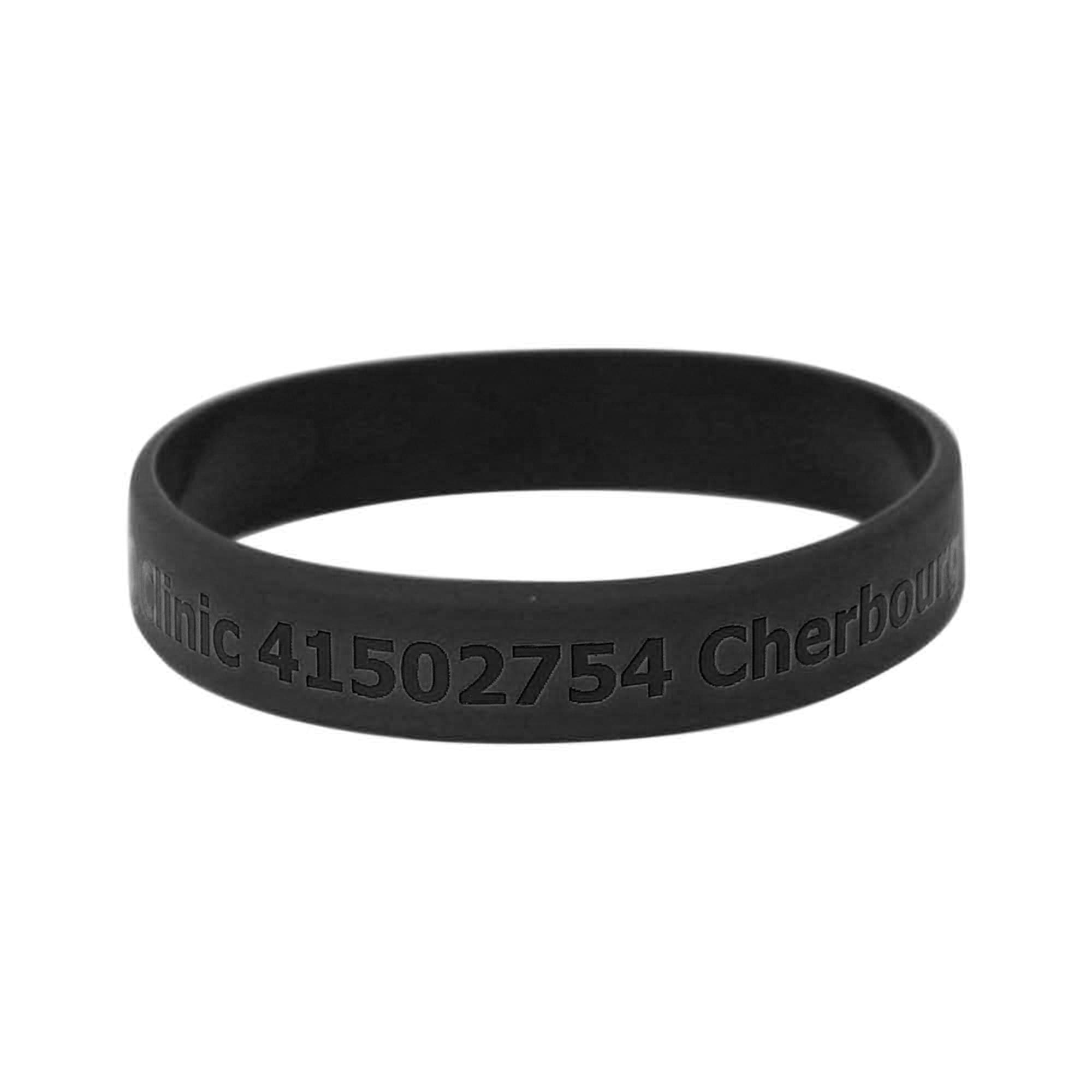 A black silicon wristband with engraved text and a logo, designed for promotional use.
