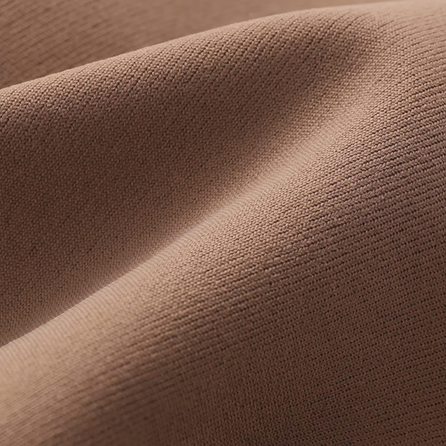 A close-up view of a soft, textured fabric in a warm, brown colour.
