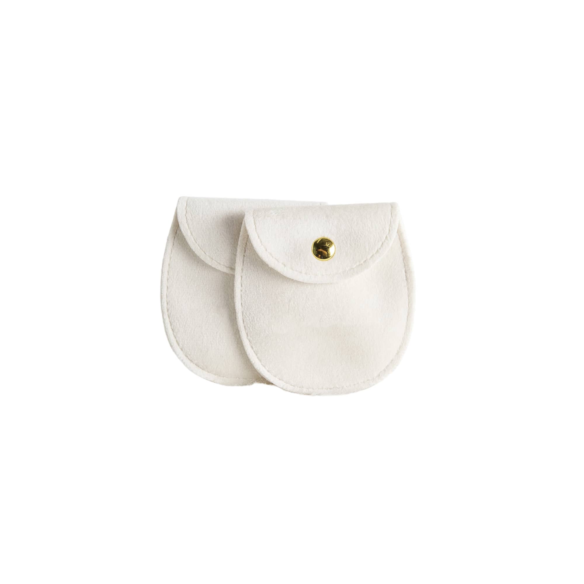 A pair of oval white velvet jewelry pouches with gold snap closures and a logo on one.