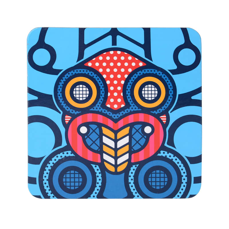 A square cork coaster featuring vibrant blue, red, and black patterns with a stylised design and a logo.