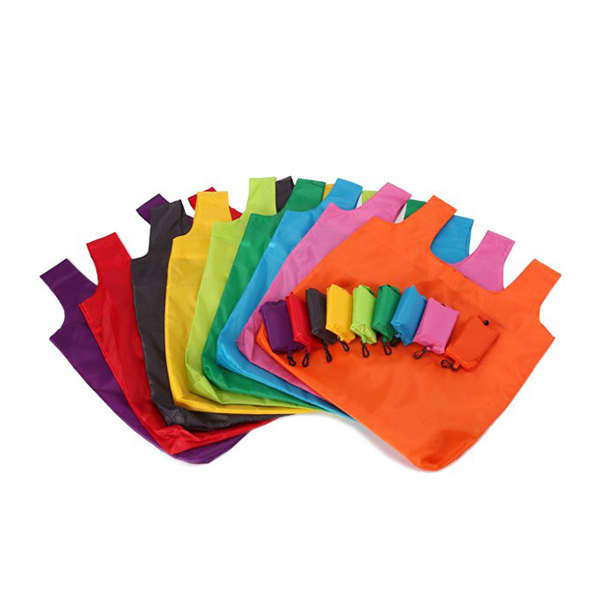 A variety of compact foldable shopping tote bags in multiple vibrant colours, arranged neatly, with matching pouches.