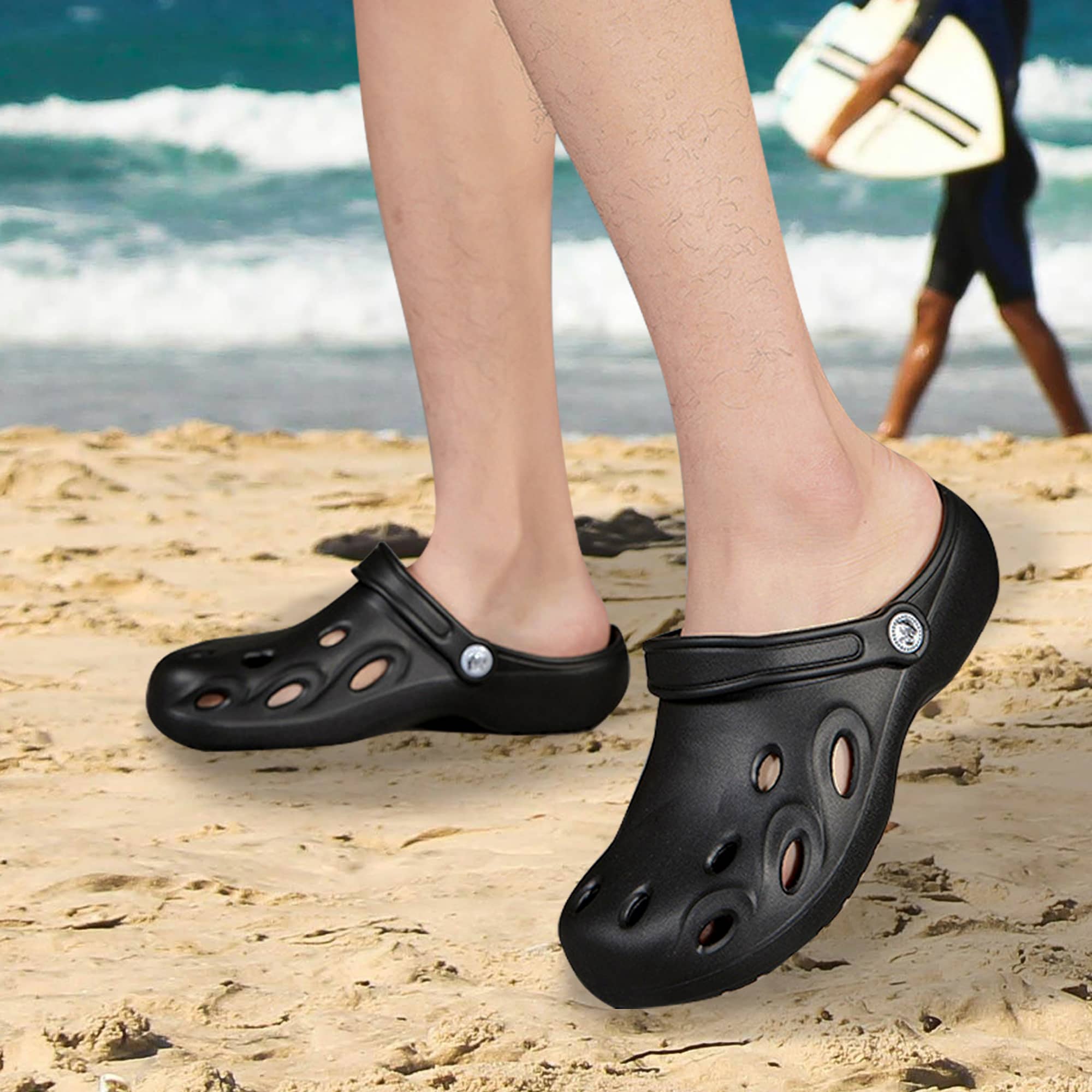Black Clog Slides with ventilation holes on sandy beach, featuring a logo on the side, suitable for casual wear.