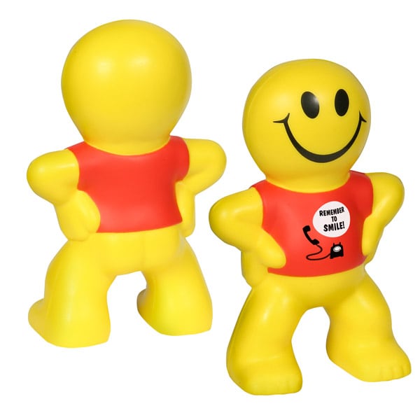 A yellow, smiling stress reliever shaped like a person, with a red shirt and a cheerful expression.
