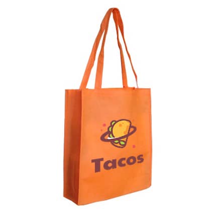 An orange non-woven bag with a large gusset and a logo featuring a taco design.