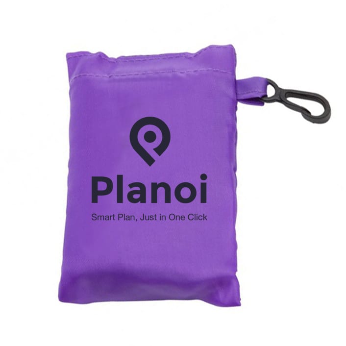 A purple foldaway shopping bag with a clip, compactly stored in a small pouch featuring a logo.