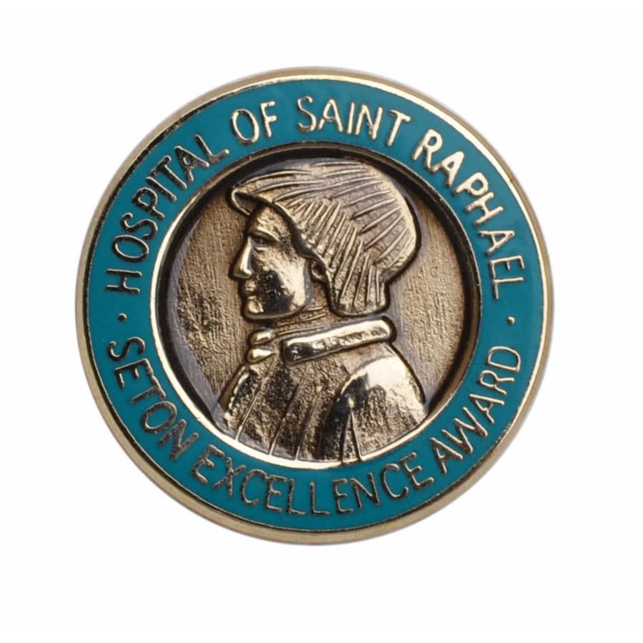 A circular hard enamel pin featuring a profile of a figure with a blue border, embossed with text and a logo.