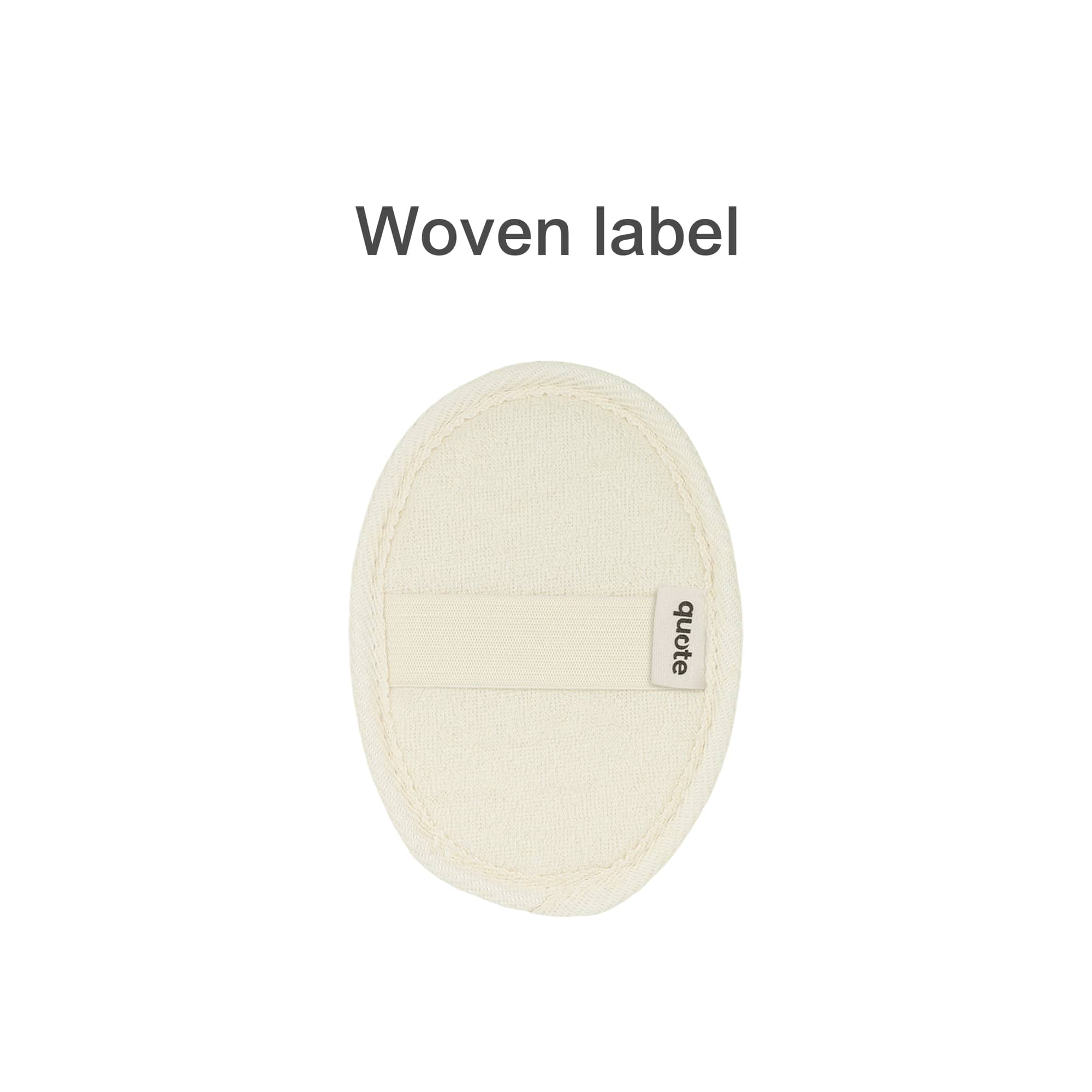 A natural cotton linen bath sponge pad in a cream colour with a woven label attached.