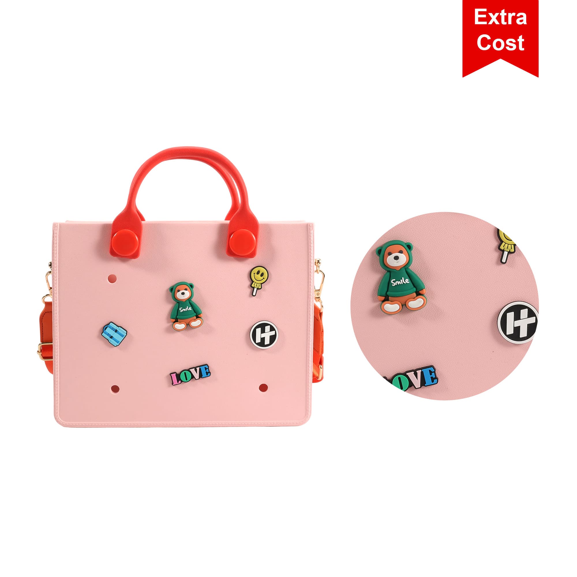 A pink tote bag with red handles featuring decorative stickers and a logo. The bag has a playful design and visual details.