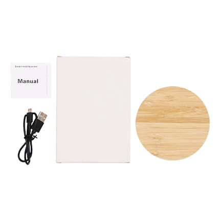 A bamboo wireless charger in a circular shape, accompanied by a manual and a USB cable.