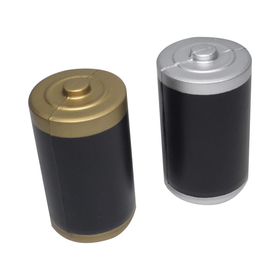 A battery-shaped stress reliever in gold and silver with a black body, featuring a branding logo.