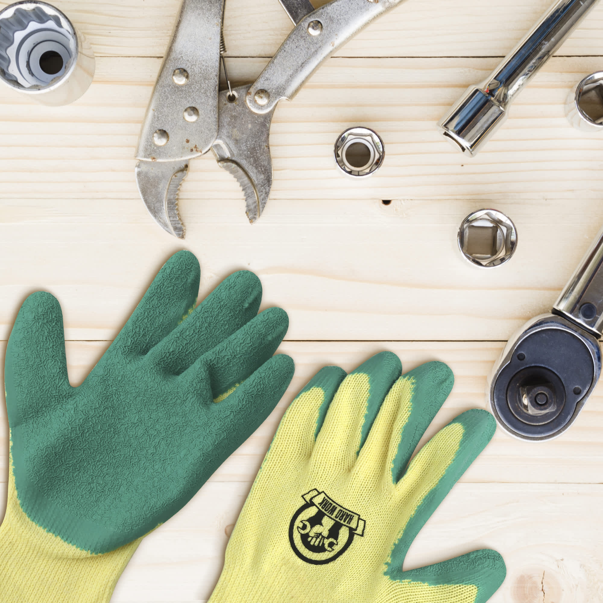 Latex dipped gloves in green and yellow, placed on a wooden surface alongside various tools.