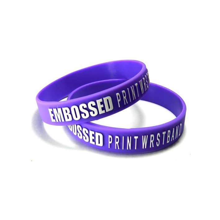 A pair of purple silicone wristbands with embossed text. One wristband features a logo.