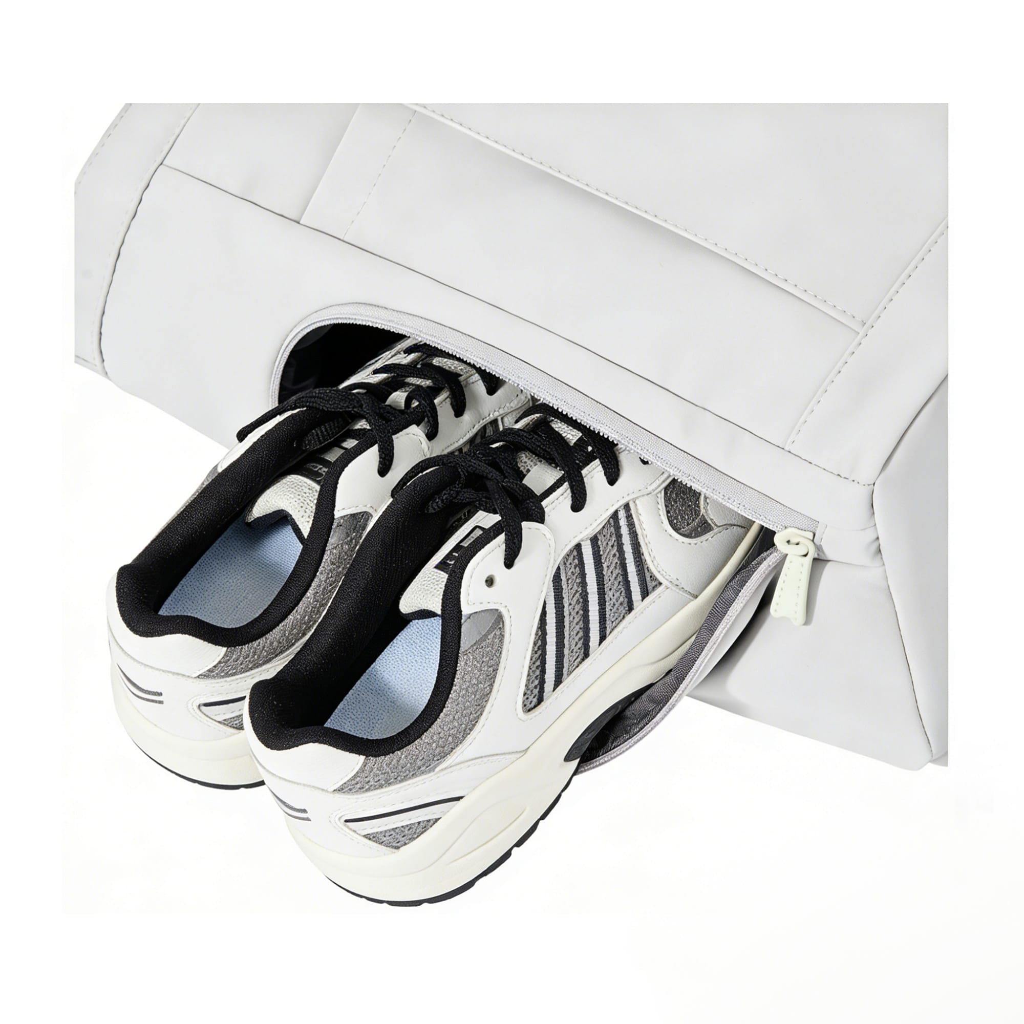A lightweight tennis tote bag in white with a zippered compartment holding a pair of sneakers. It features a logo.