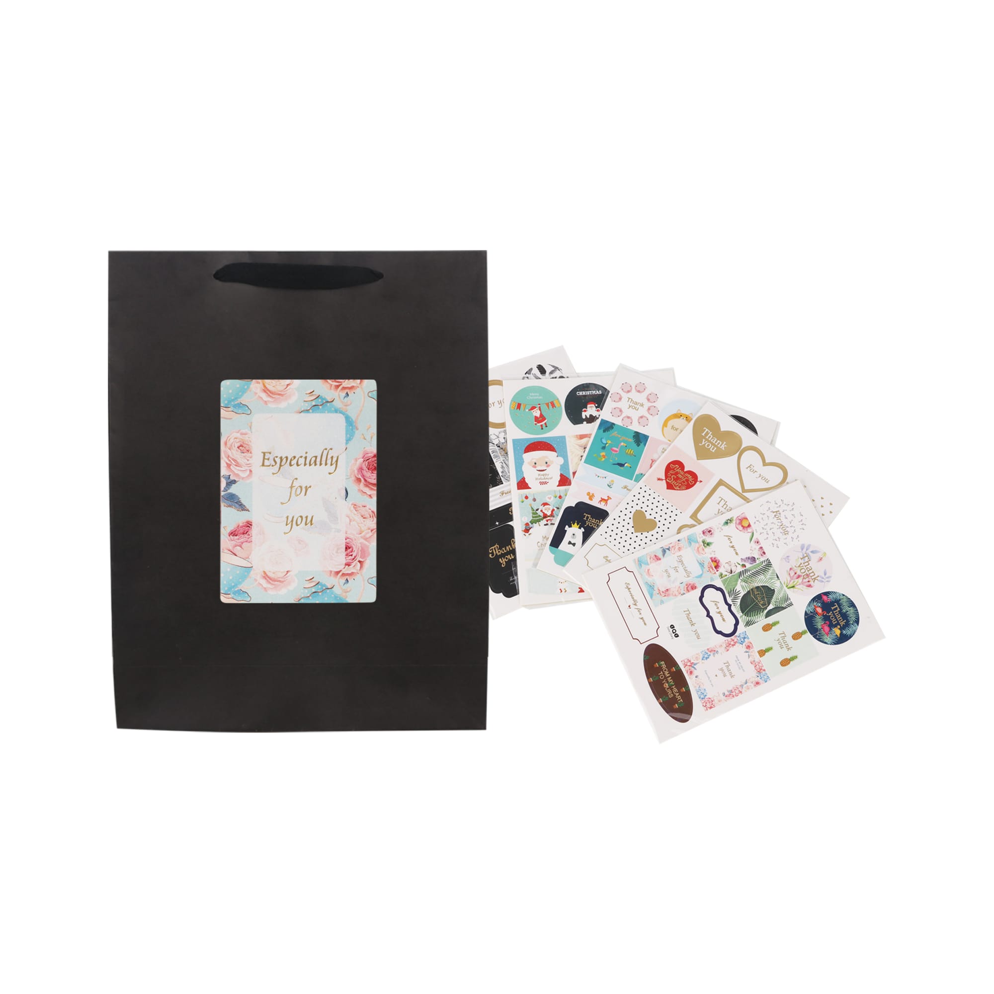 A medium vertical black paper bag with a fabric flat handle and assorted decorative stickers inside.