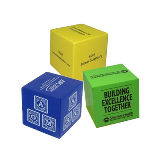 Three cube-shaped stress relievers in yellow, blue, and green, each featuring different designs and a logo.