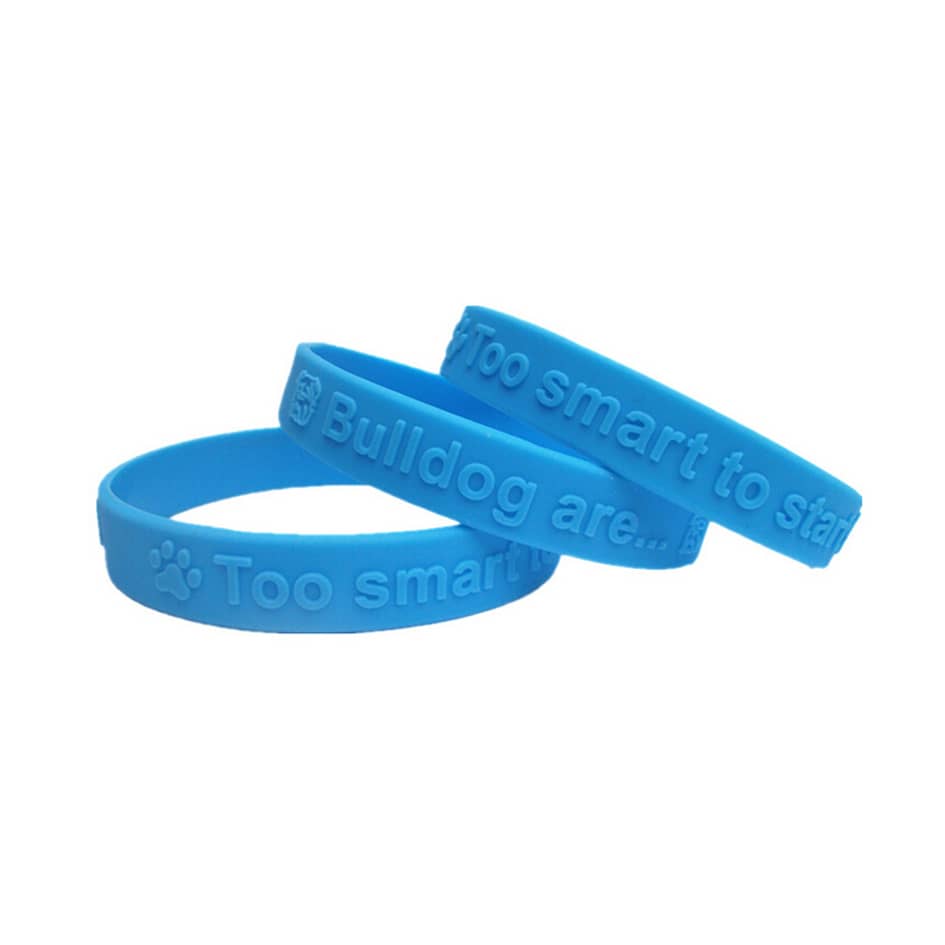 Three blue embossed silicon wristbands, featuring various phrases and a logo.