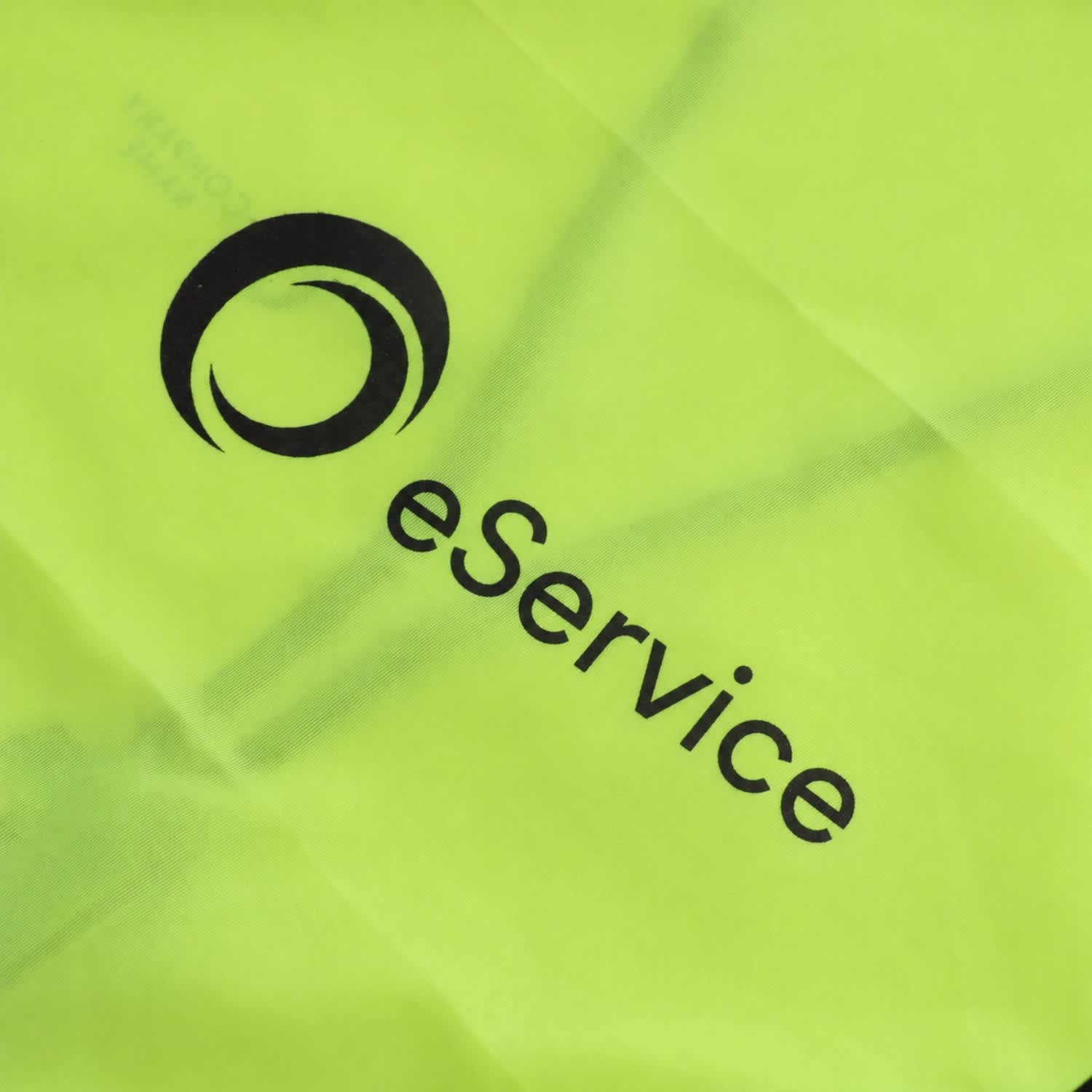 A hi-vis vest in bright yellow with horizontal reflective tape and a logo on the front.