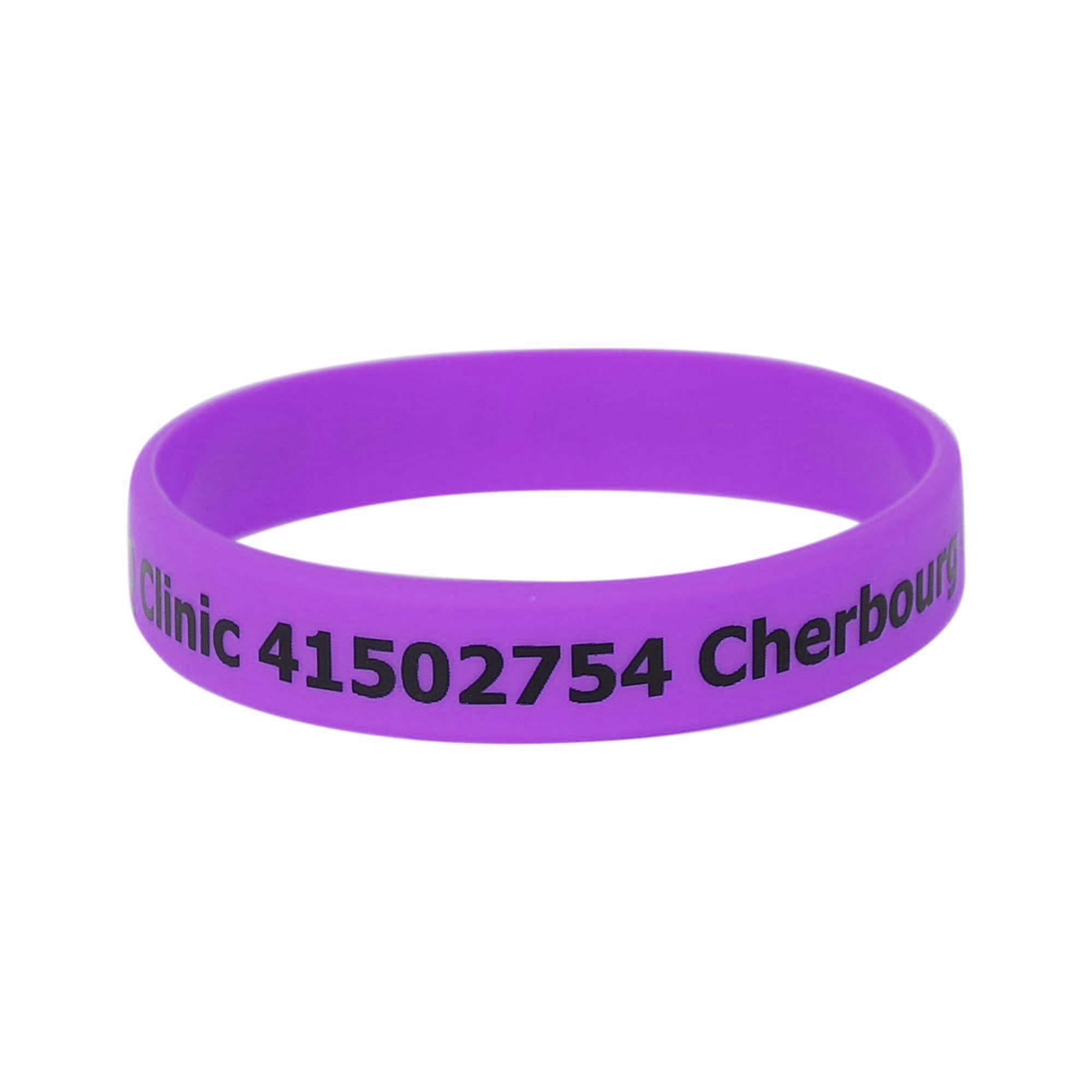 A purple silicone wristband featuring printed text and a logo.