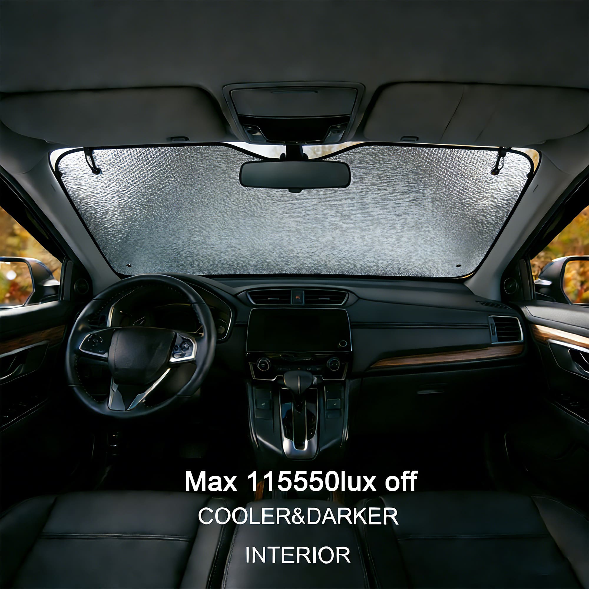 A bubble aluminium car sunshade in silver, fitted inside a car, blocking sunlight from the front windshield.