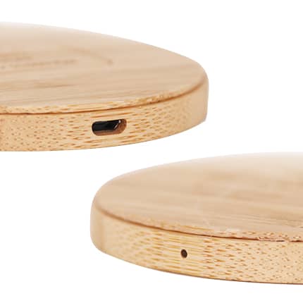 A bamboo wireless charger with a smooth, circular design and a USB-C port on the side. It has a natural wood finish.
