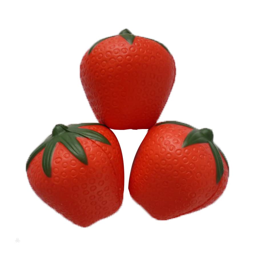 Three red strawberry-shaped stress relievers with green leaves on top, featuring a textured surface.