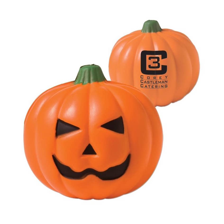 An orange pumpkin stress reliever with a smiling face and black features, featuring a logo on one side.