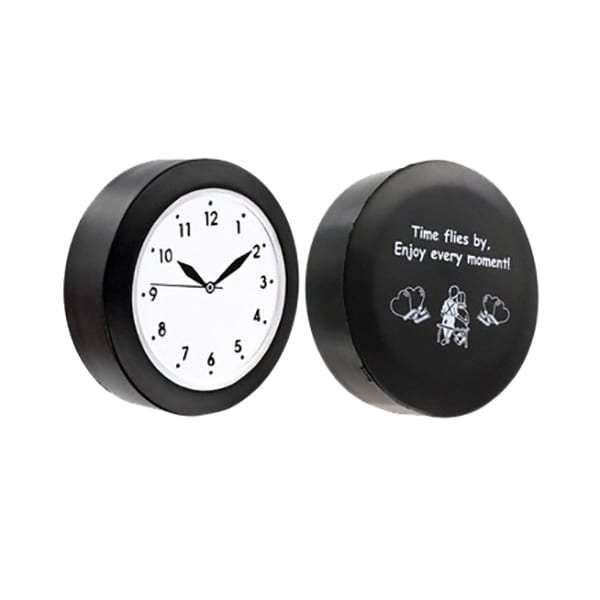 A black quart clock-shaped stress reliever featuring a white clock face and a motivational message on the reverse side.