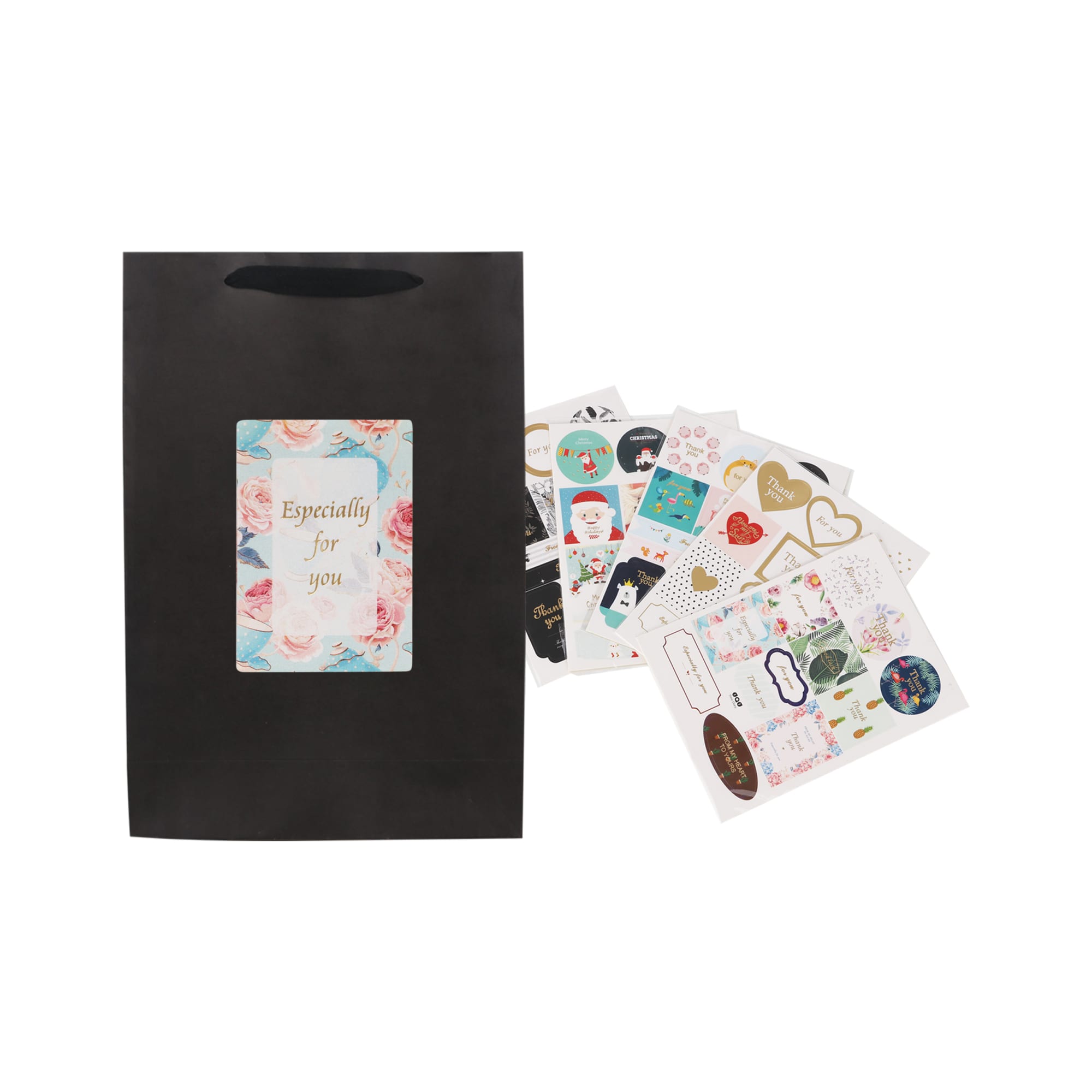 A black vertical paper bag with a rope handle, accompanied by various decorative stickers.