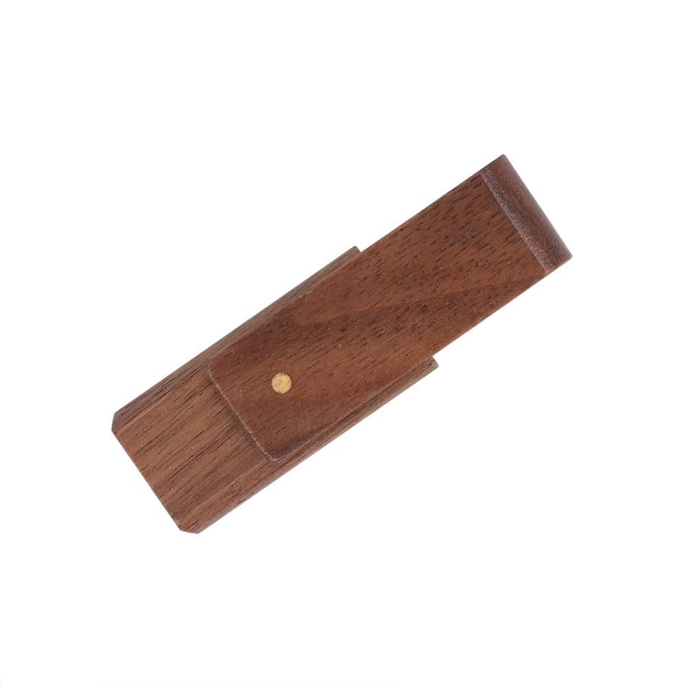 A wooden flash drive in a dark brown finish with a small gold dot, featuring a sleek, minimalist design.