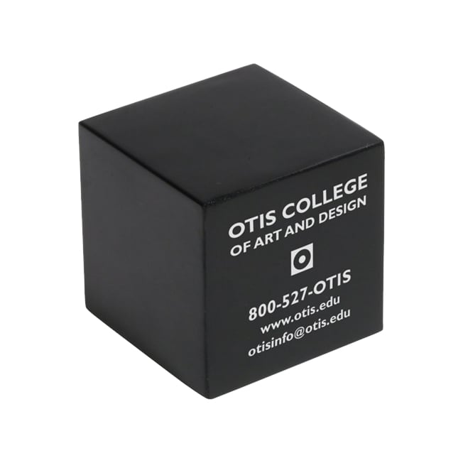 A black cube-shaped stress reliever with a logo and text on one side.