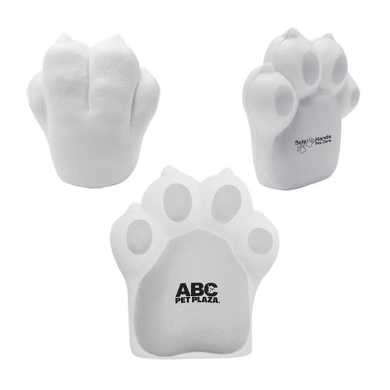 A dog paw-shaped stress reliever in white, featuring a logo on one side.