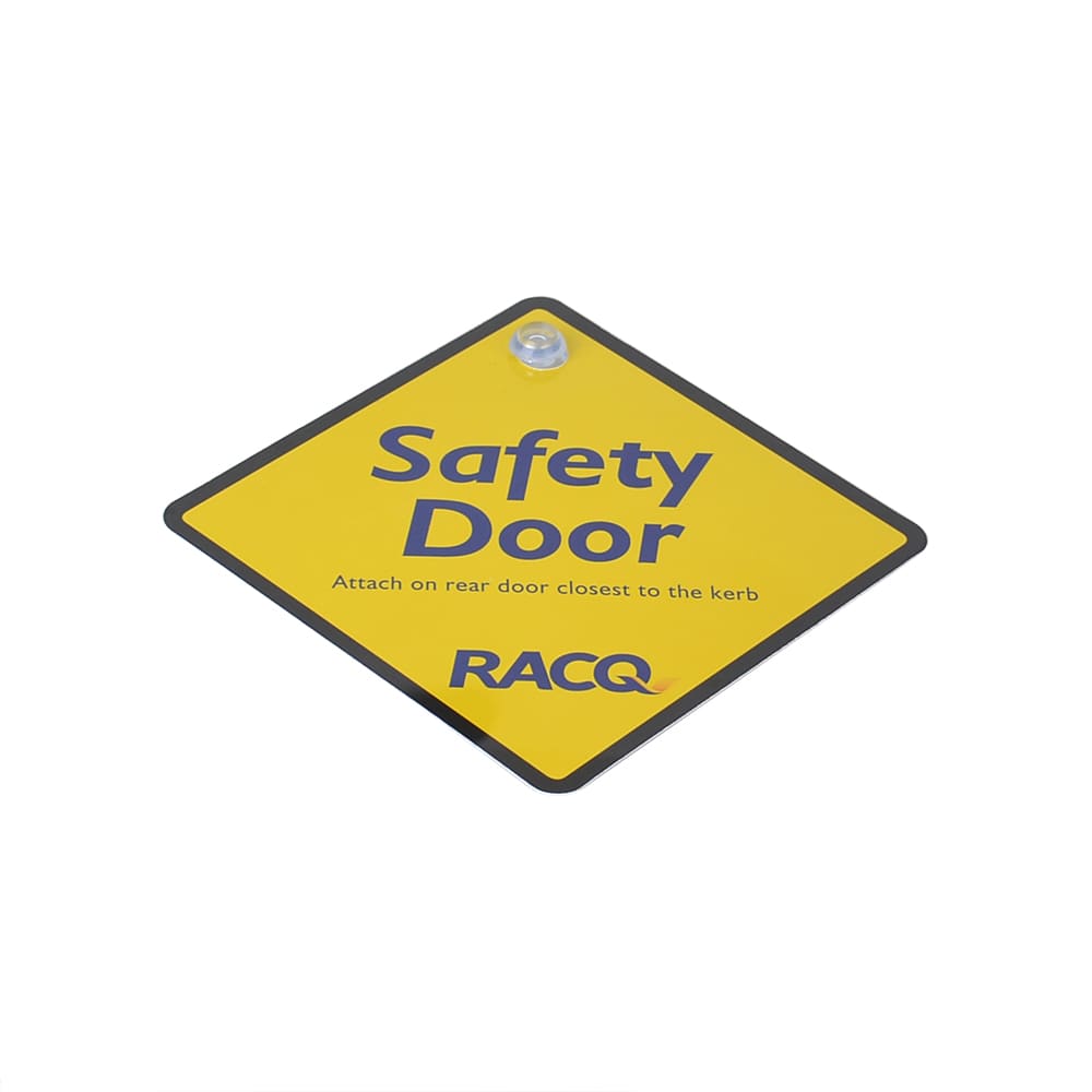 A yellow diamond-shaped warning sign with the text "Safety Door" and a logo, used for exhibitions and events.