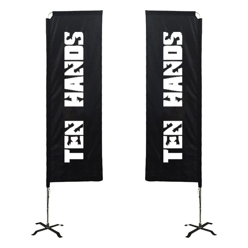 Two large rectangular banners in black with a logo. They are mounted on stands.