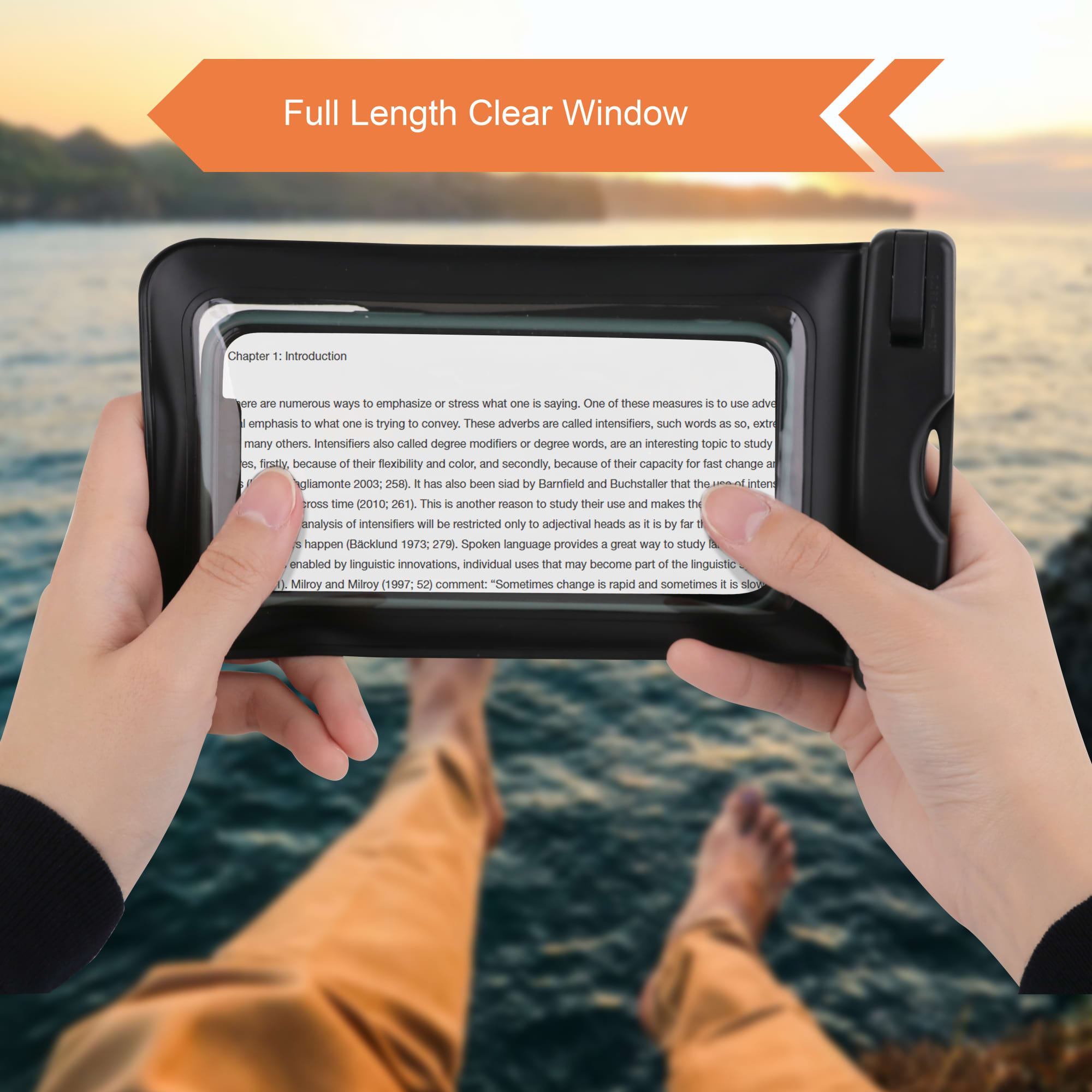 A waterproof phone bag with a full-length clear window, black in colour, held by two hands against a scenic background.