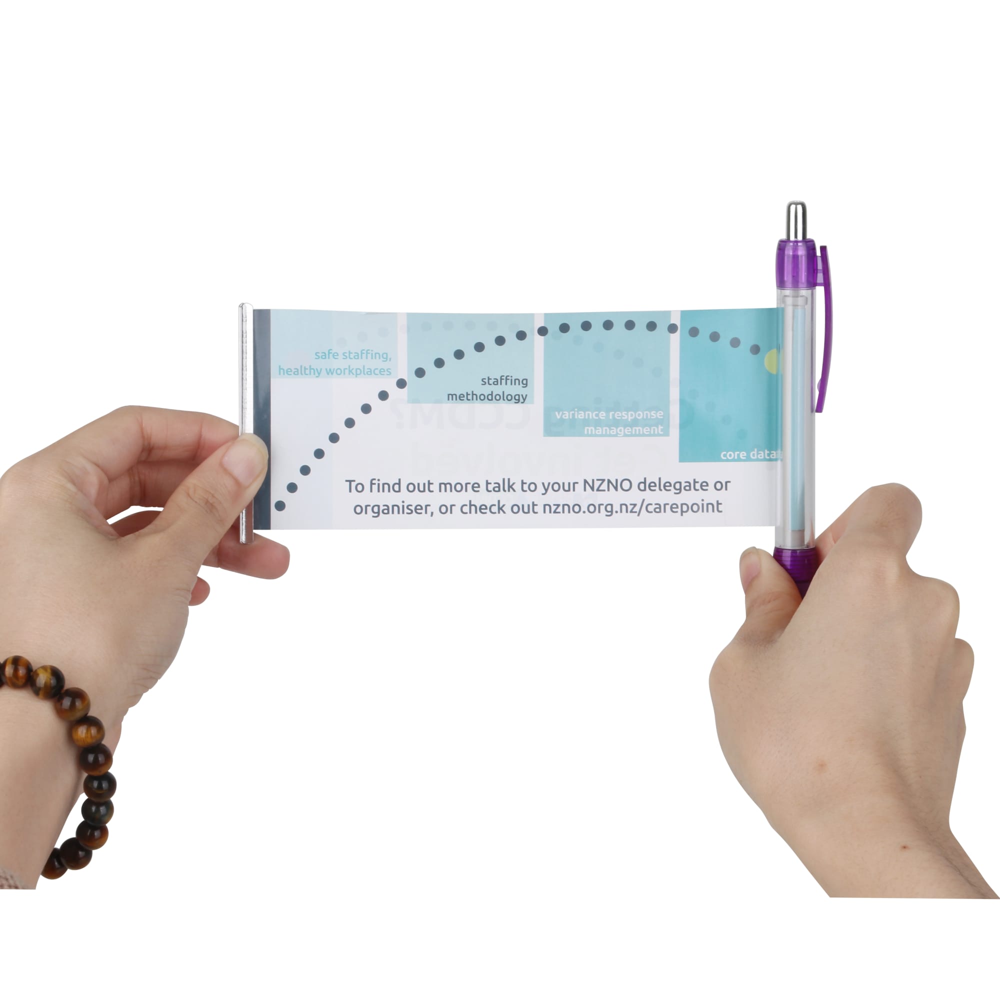 A purple plastic pen featuring a banner design, held between two hands, with various graphics and text visible.