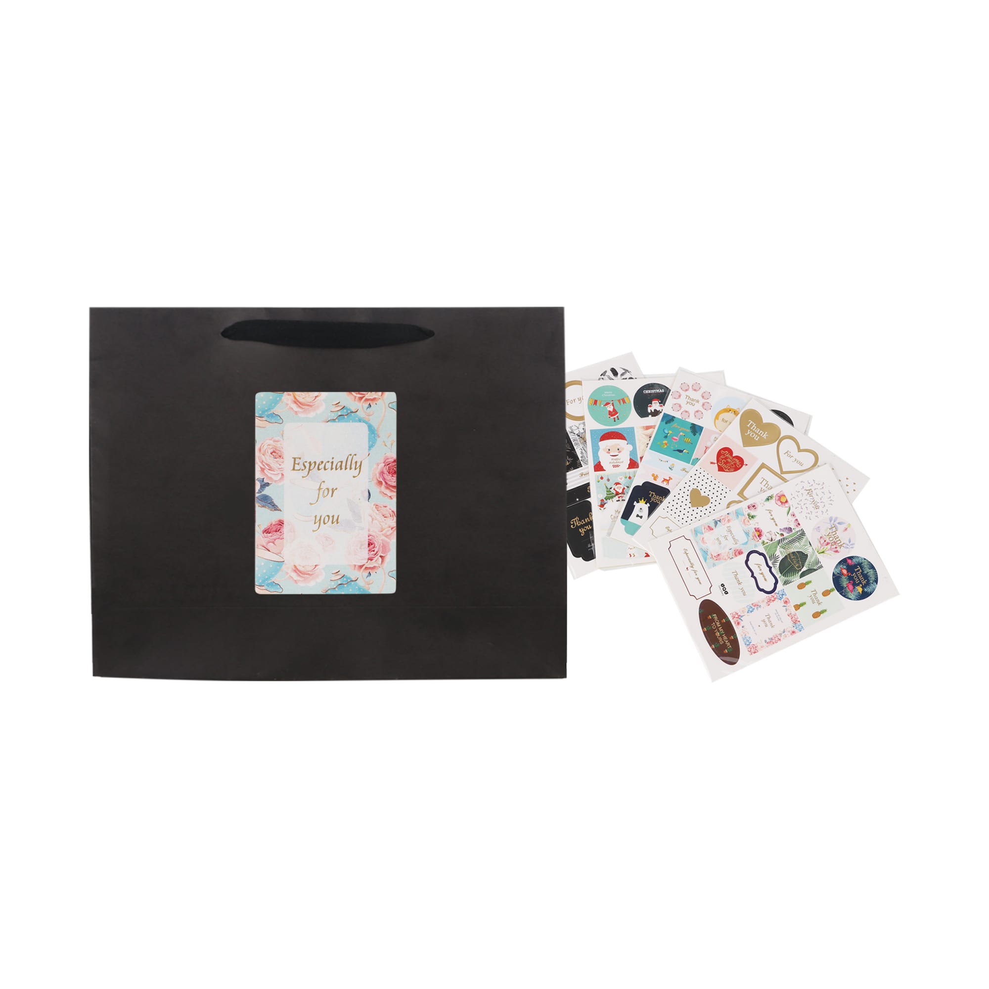 A small black crosswise paper bag with a rope handle, accompanied by various decorative stickers.