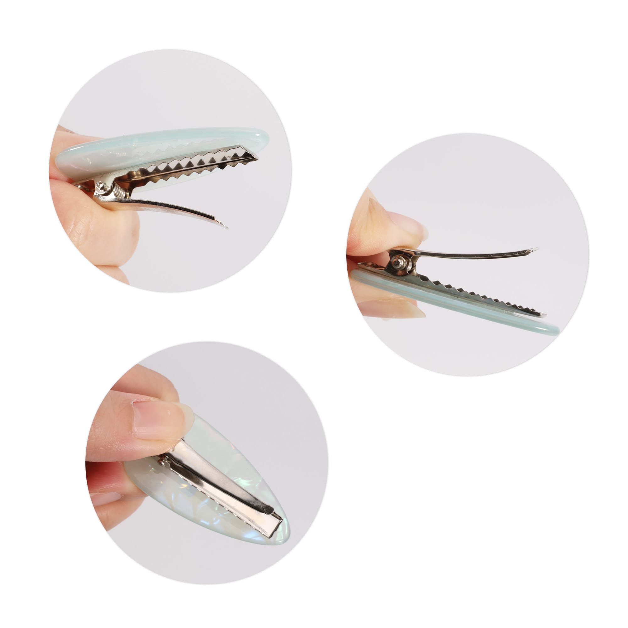 A teardrop-shaped iridescent alligator hair clip in light blue, shown from multiple angles, with a silver clip mechanism.