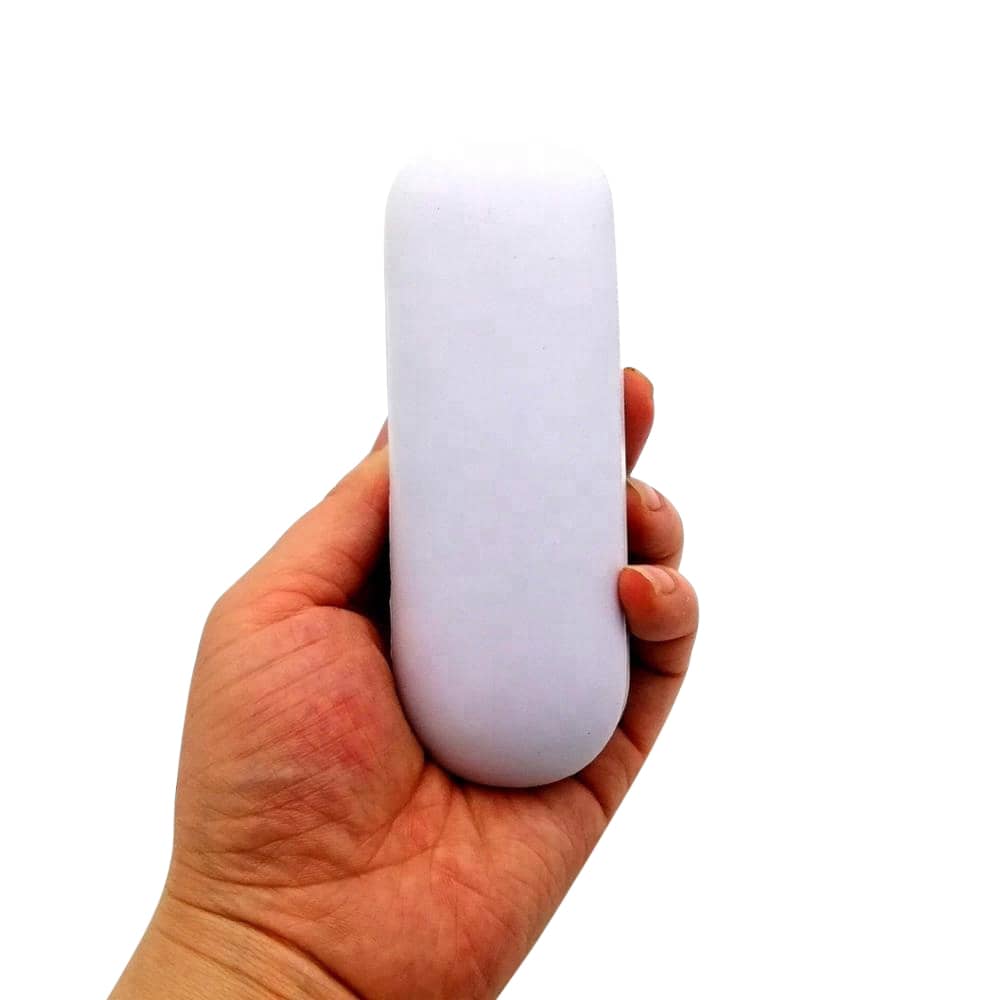 A hand holds a white, oval-shaped stress reliever. The item is smooth and has a minimalist design.