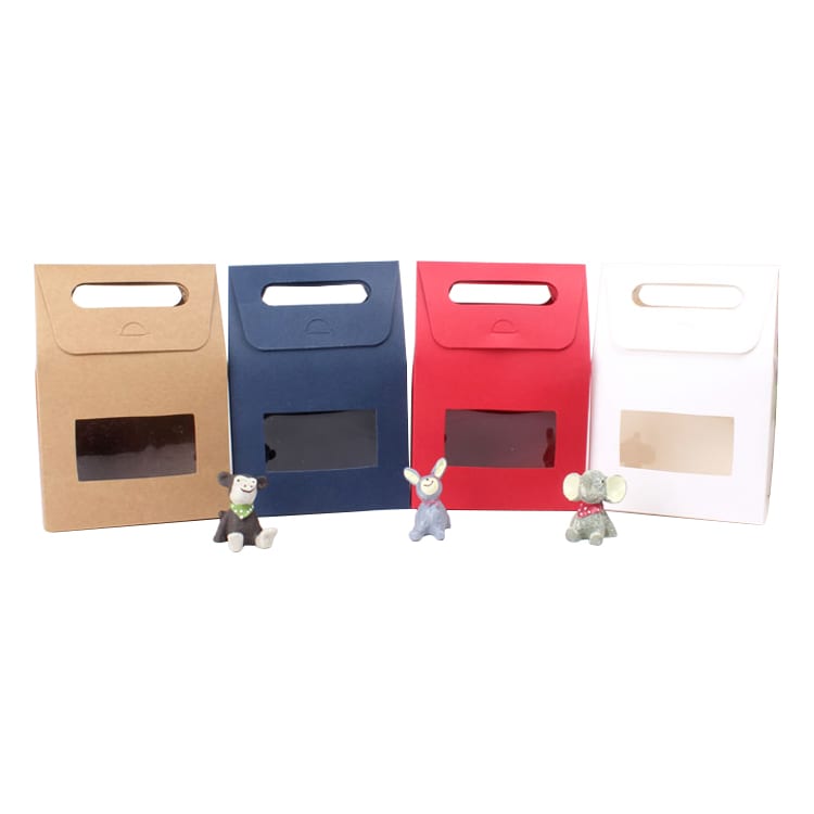 A set of die cut handle bags in brown, navy, red, and white, each with a transparent window. Small toy figures are in front.