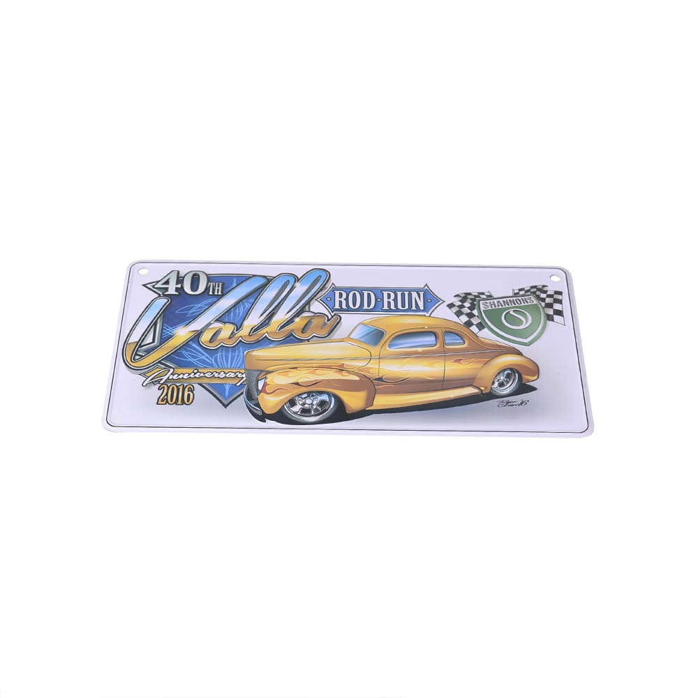 A decorative licence plate featuring a yellow classic car and illustrations, with a logo and event details.