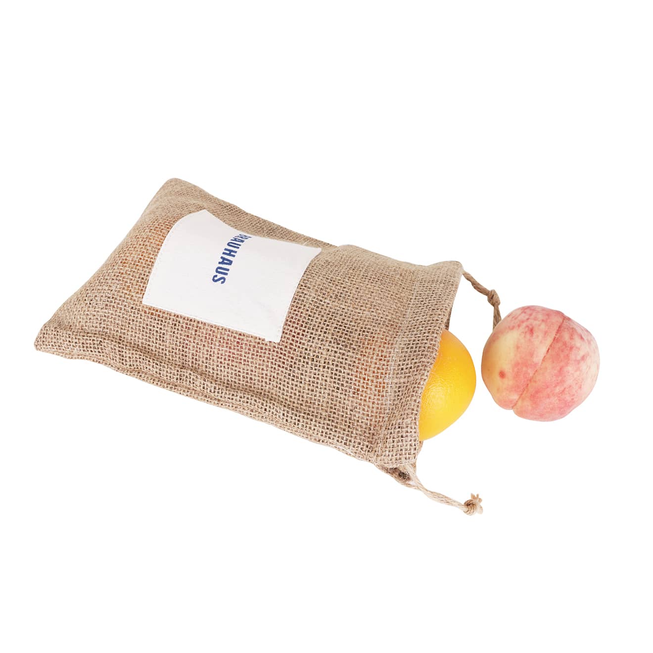 A jute net produce bag in natural brown contains an orange and a peach, with a logo visible on the front.