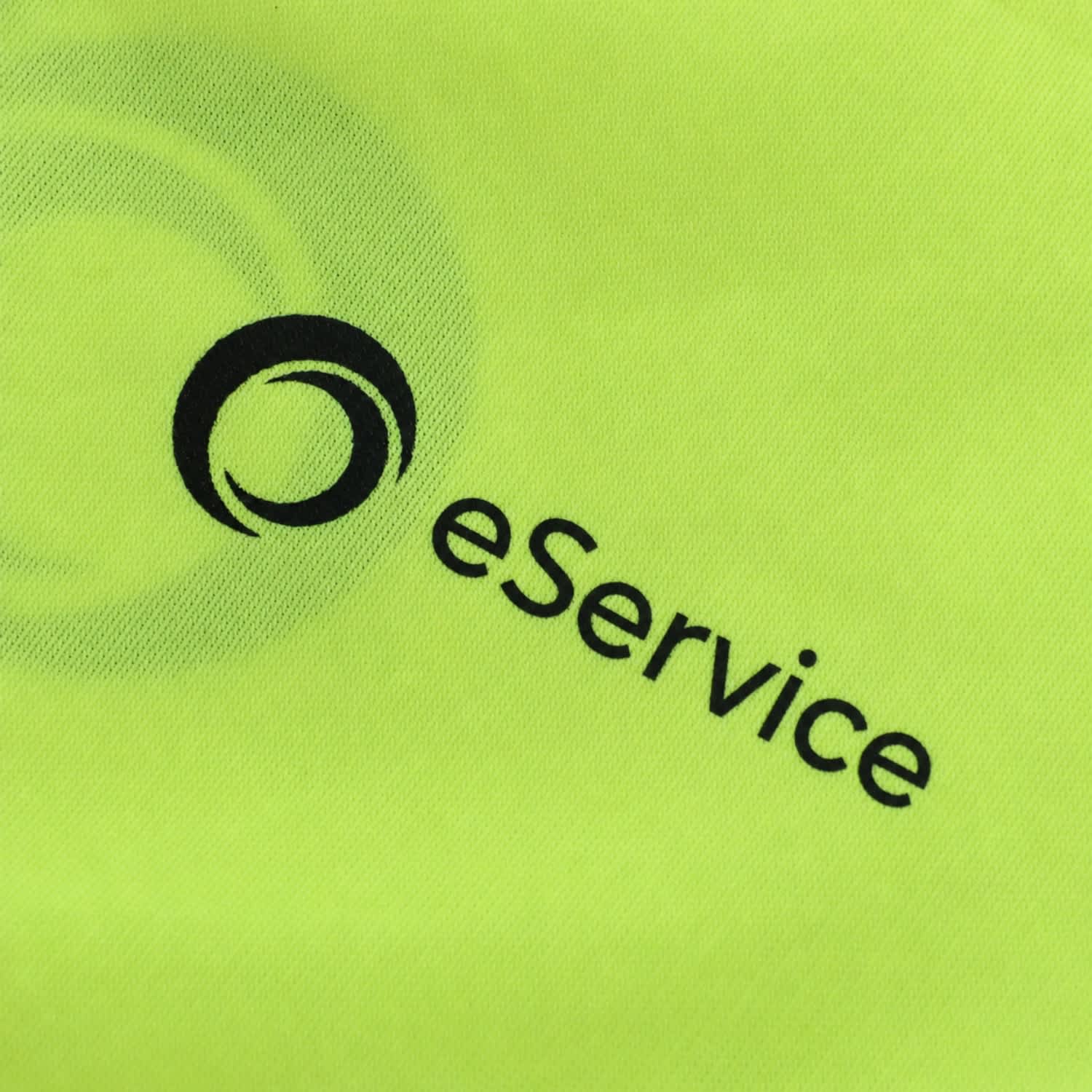 A vibrant yellow fabric featuring a logo and text. Suitable for high-visibility workwear.