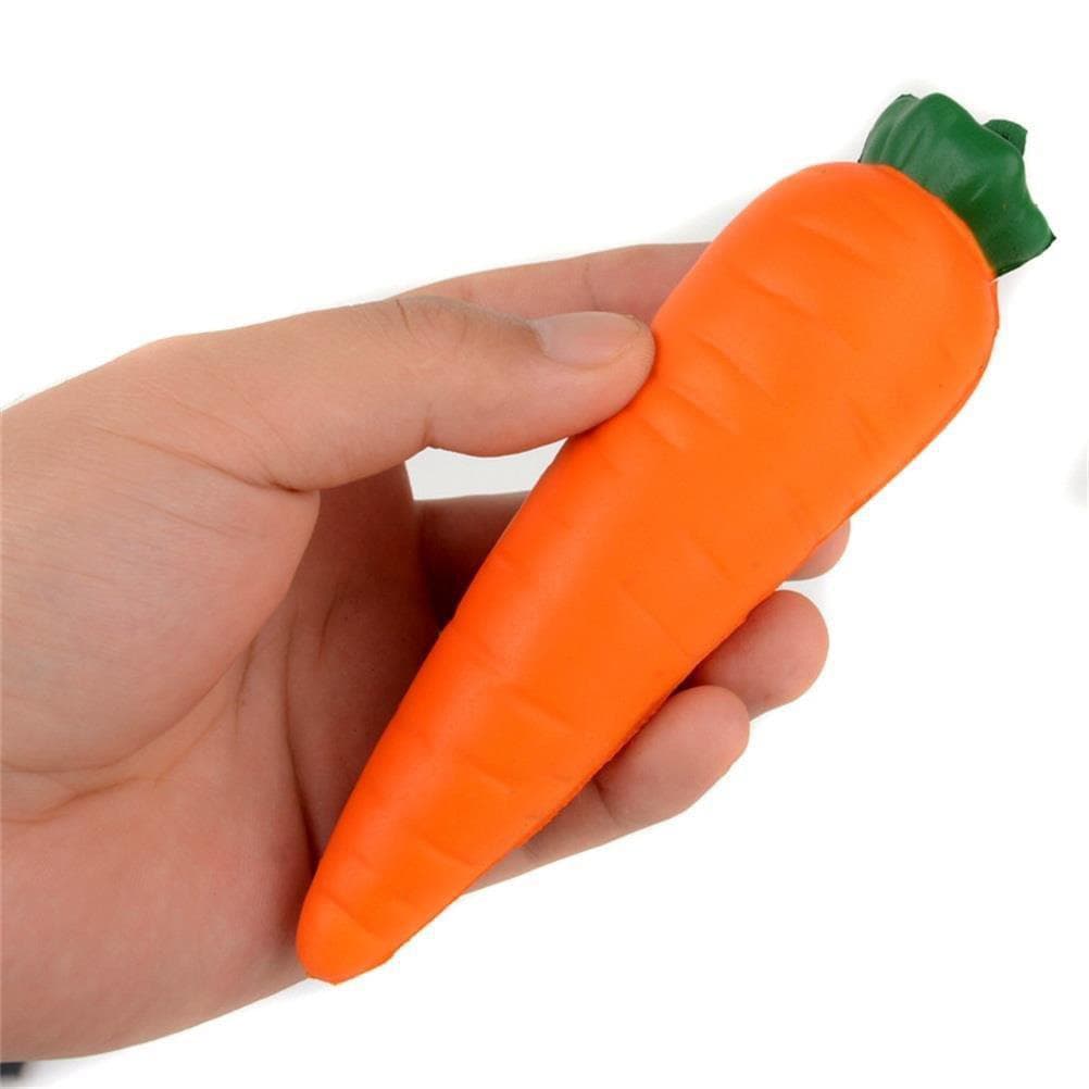 An orange carrot-shaped stress reliever held in a hand, featuring a green leafy top.