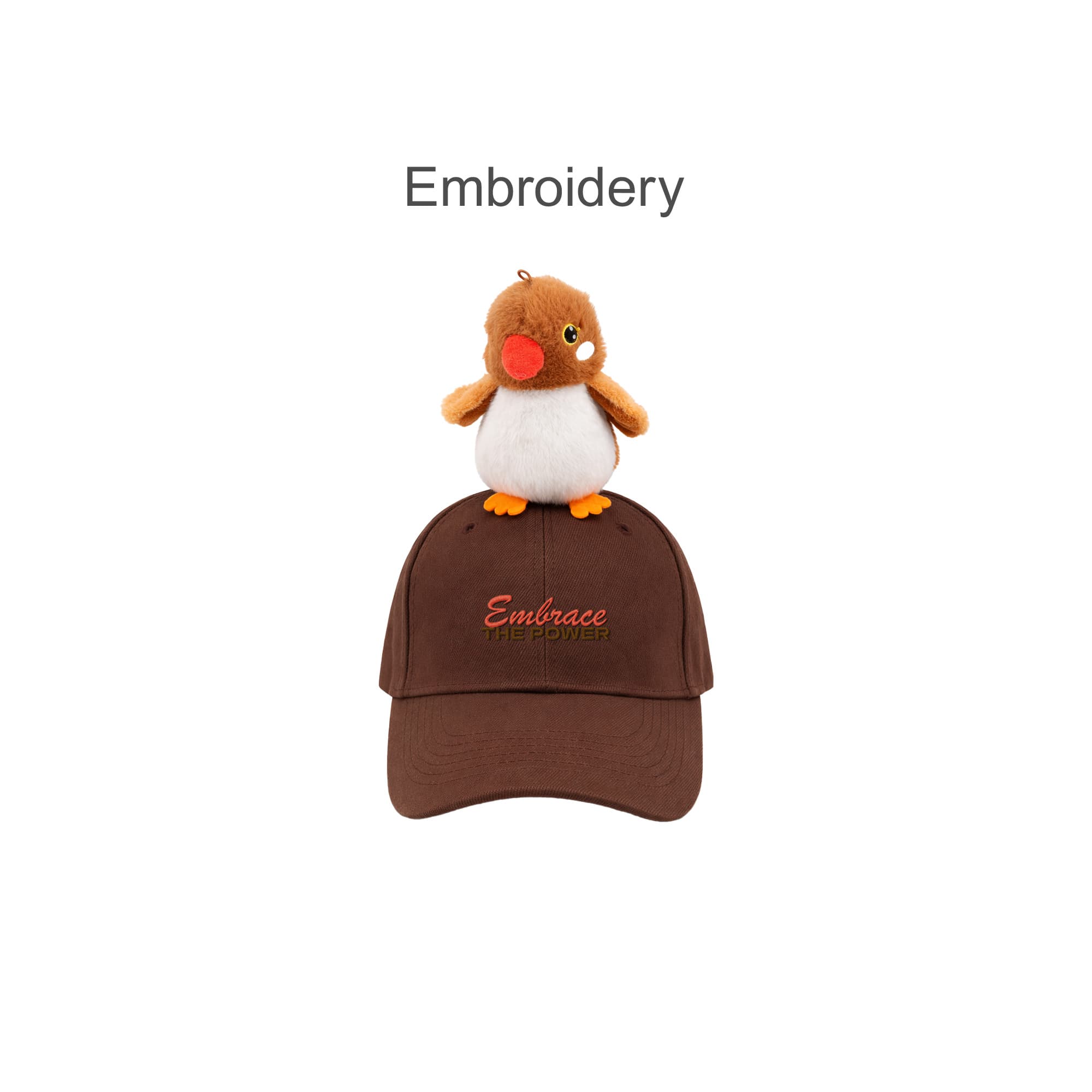 A brown baseball cap with a plush bird on top and decorated embroidery. The cap has a logo.