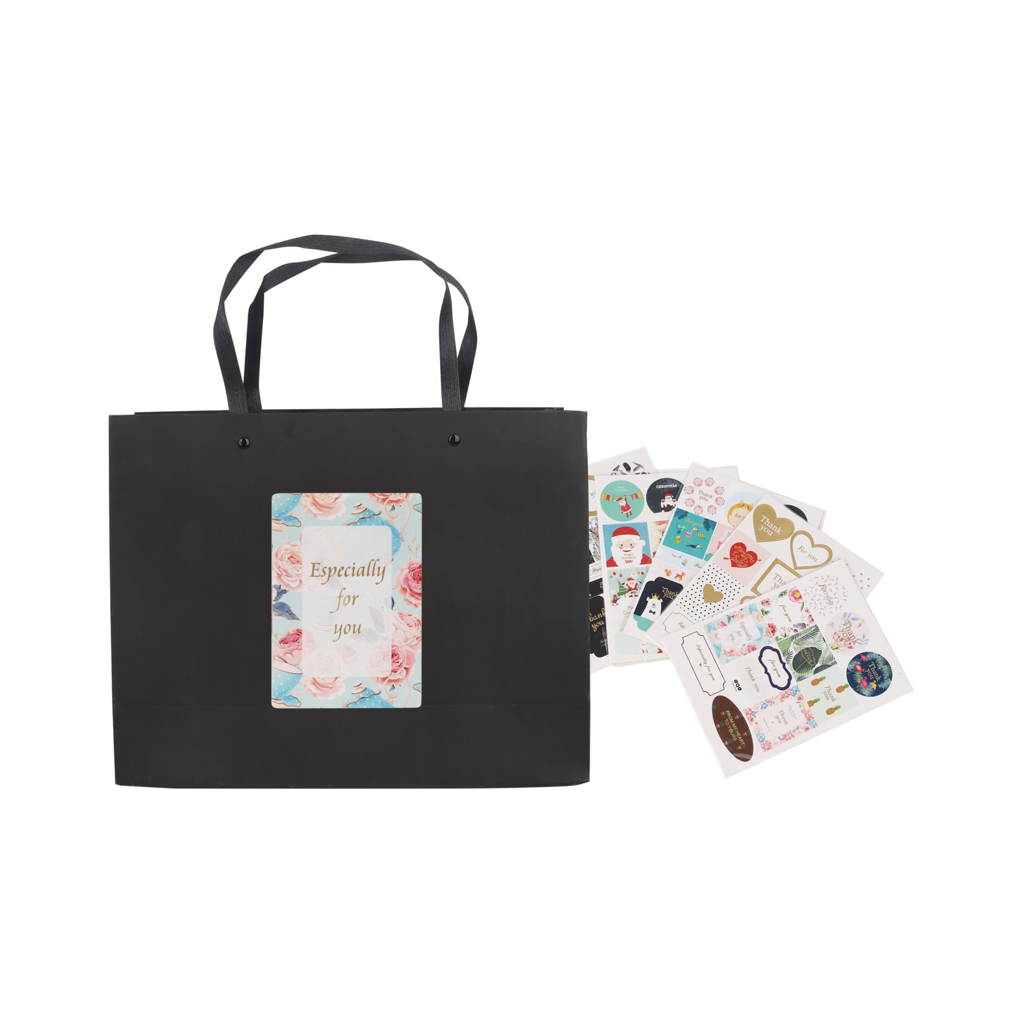 A medium black paper bag with knitted handles, accompanied by colourful decorative stickers.