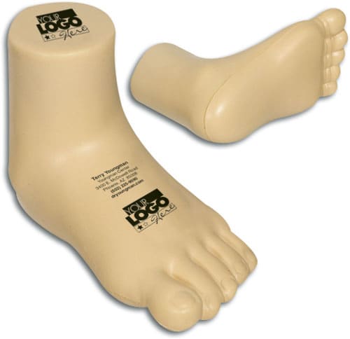 A beige baby leg-shaped stress reliever with a logo on the base, designed as a fun keyring accessory.