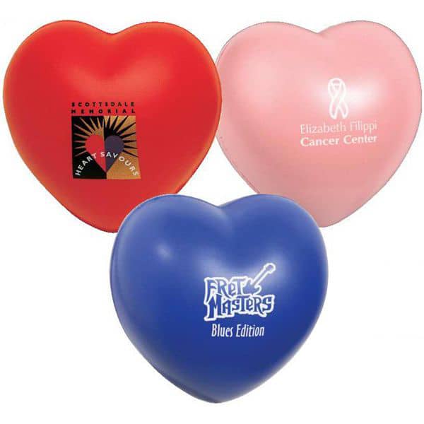 Three heart-shaped stress relievers in red, pink, and blue, featuring various logos and designs.